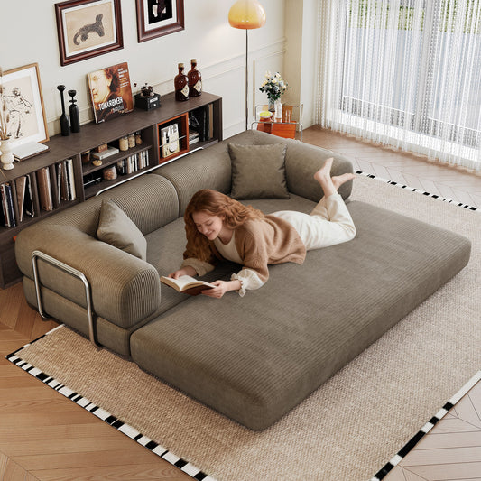 Camel corduroy boneless sofa bed unfolded flat into a bed, person lying on it — Camel