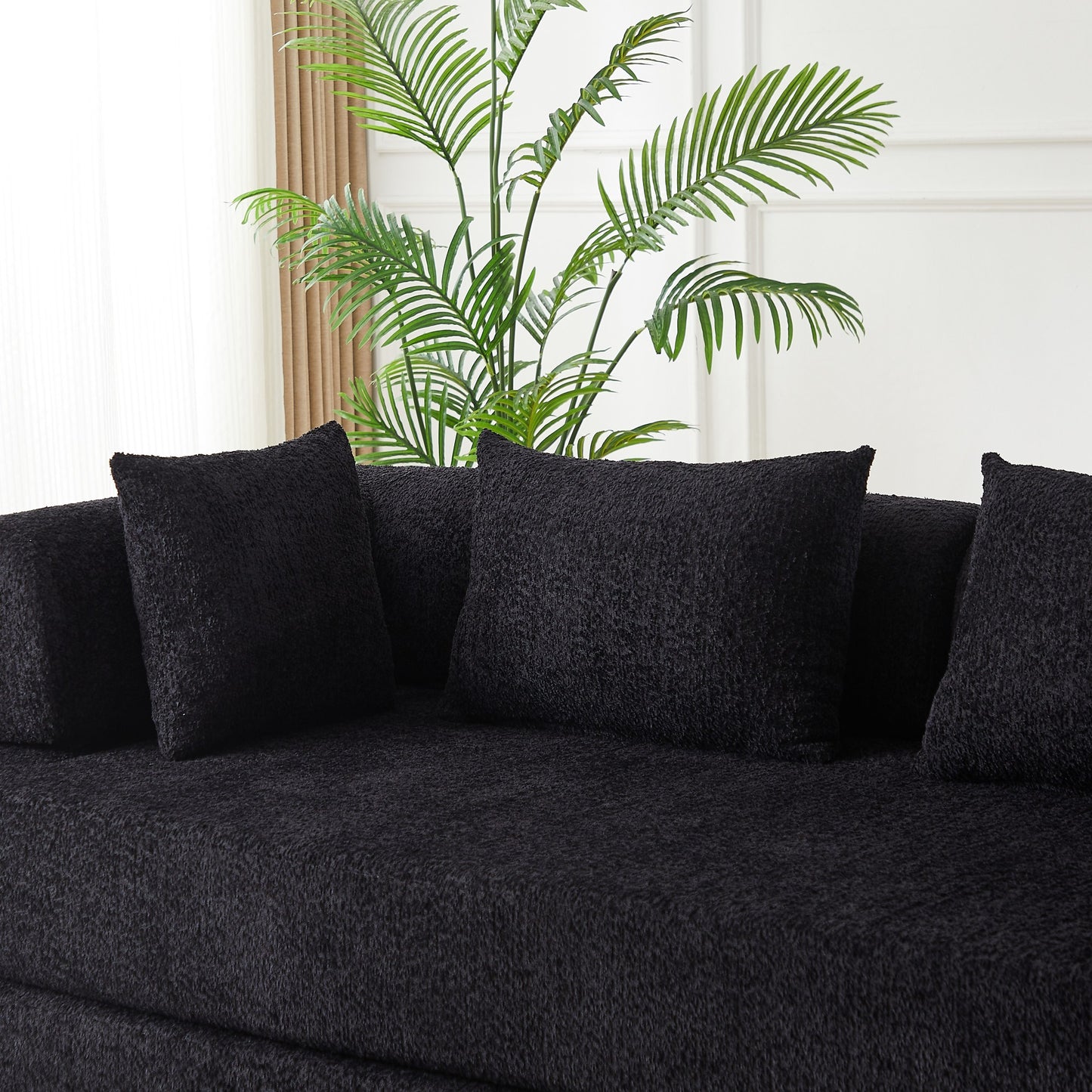 Close-up of the black chenille fabric and the bolster back cushions — Black