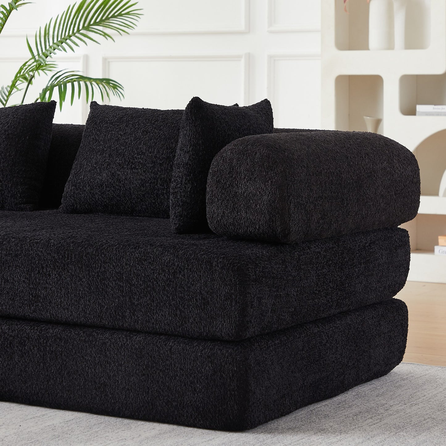 Close-up of the folded foam layers and black chenille upholstery — Black
