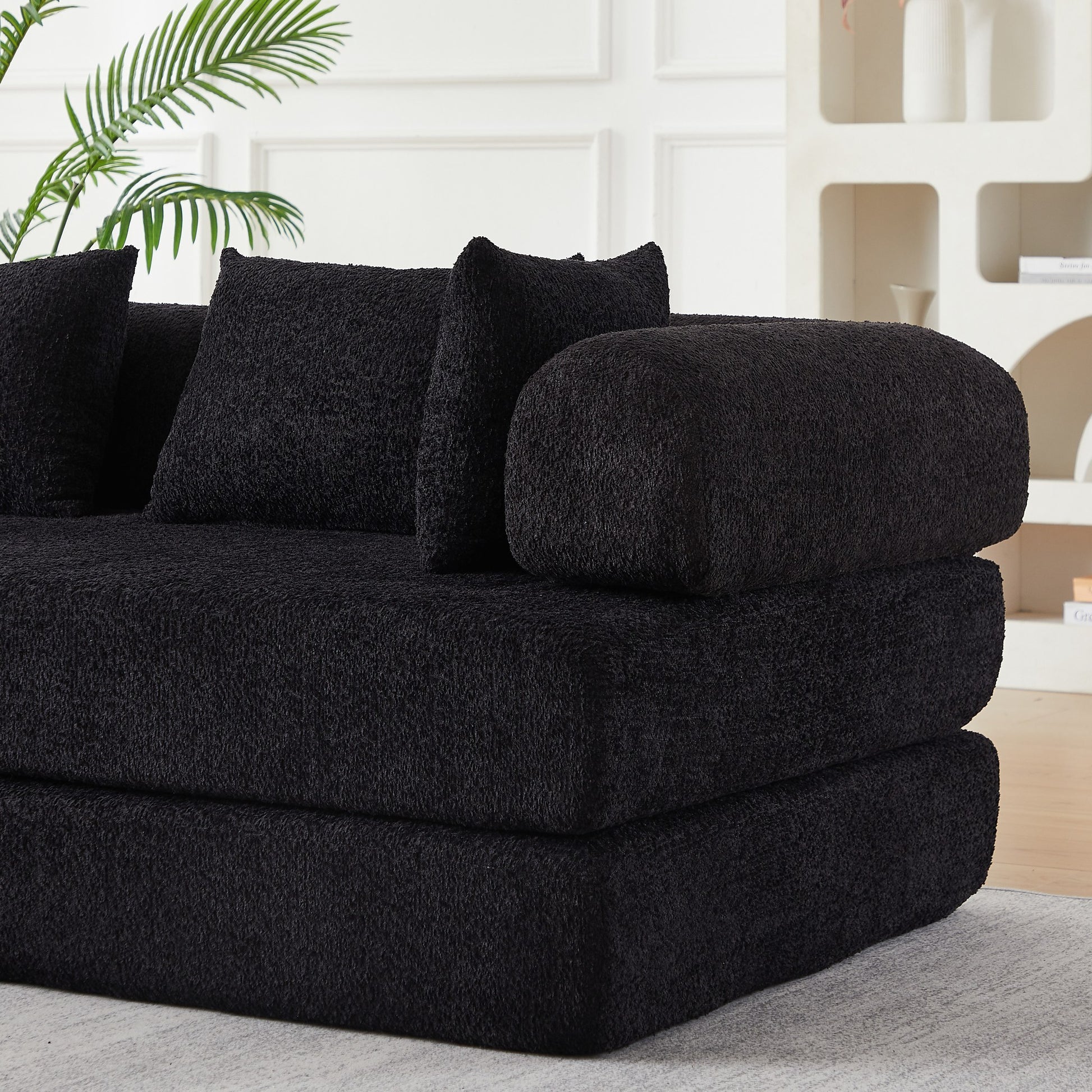 Close-up of the folded foam layers and black chenille upholstery — Black
