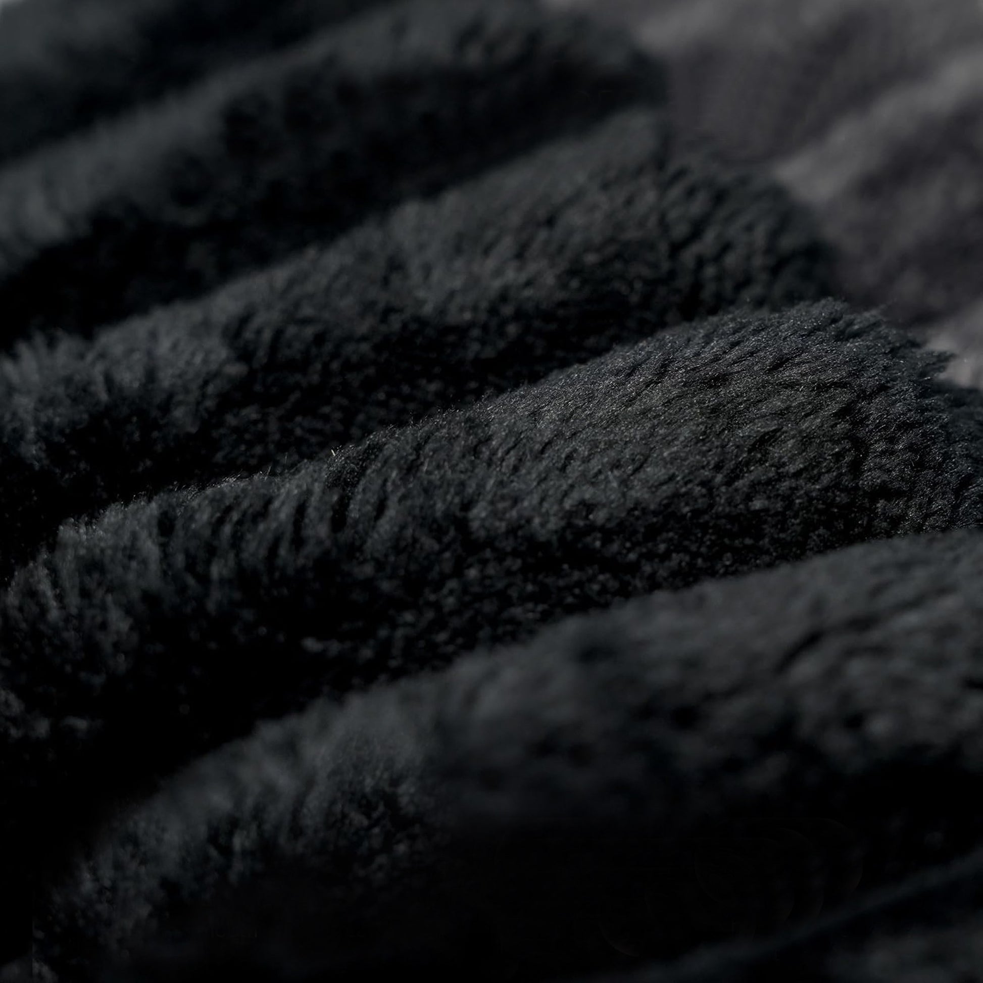 Close-up of the wide-wale black corduroy fabric and channel stitching — Black / 2-Seat (63"W)