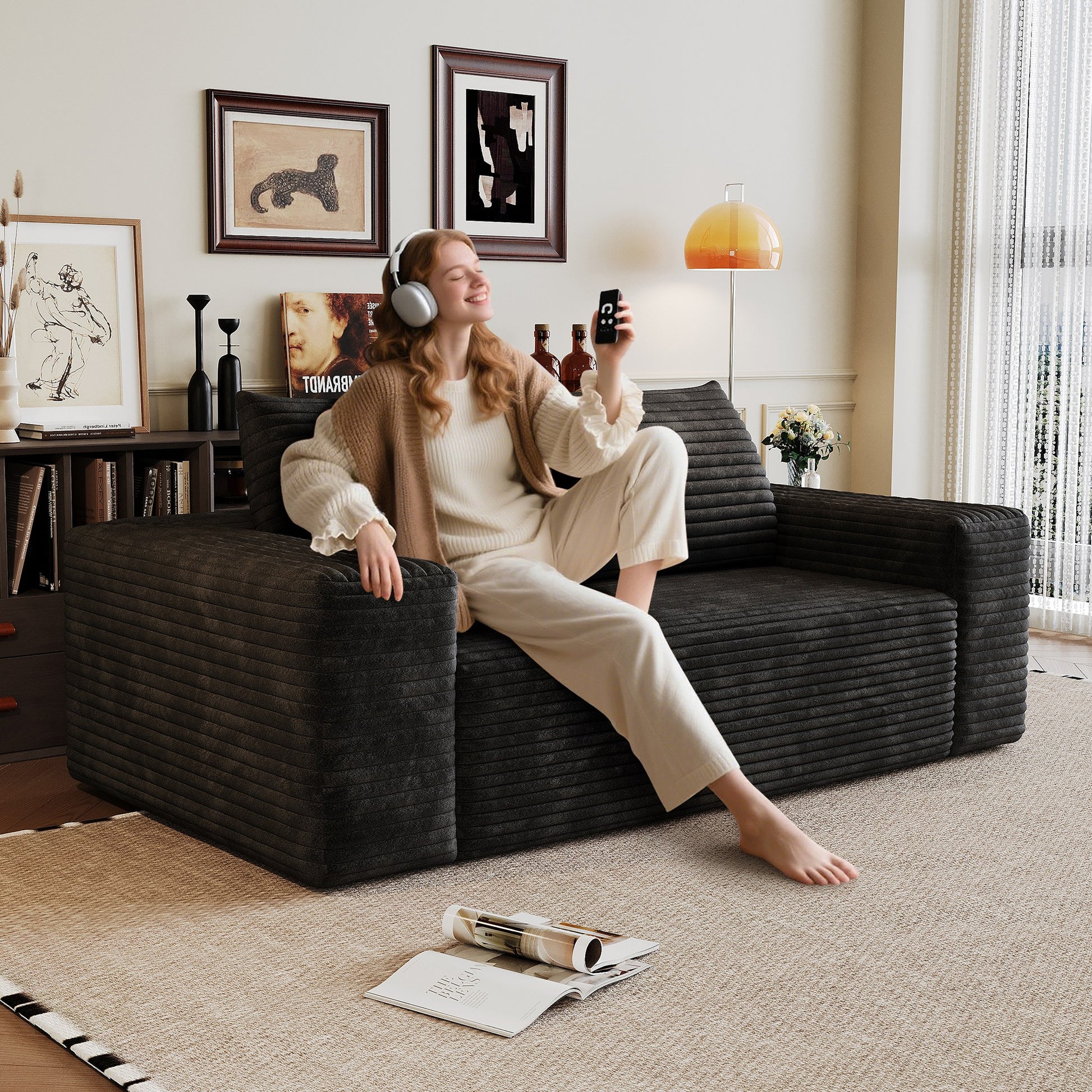 Woman relaxing on the black corduroy boneless sofa, 2-seat 63-inch, showing seat depth — Black / 2-Seat (63"W)