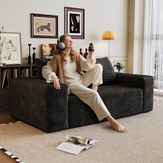 Woman relaxing on the black corduroy boneless sofa, 2-seat 63-inch, showing seat depth — Black / 2-Seat (63"W)