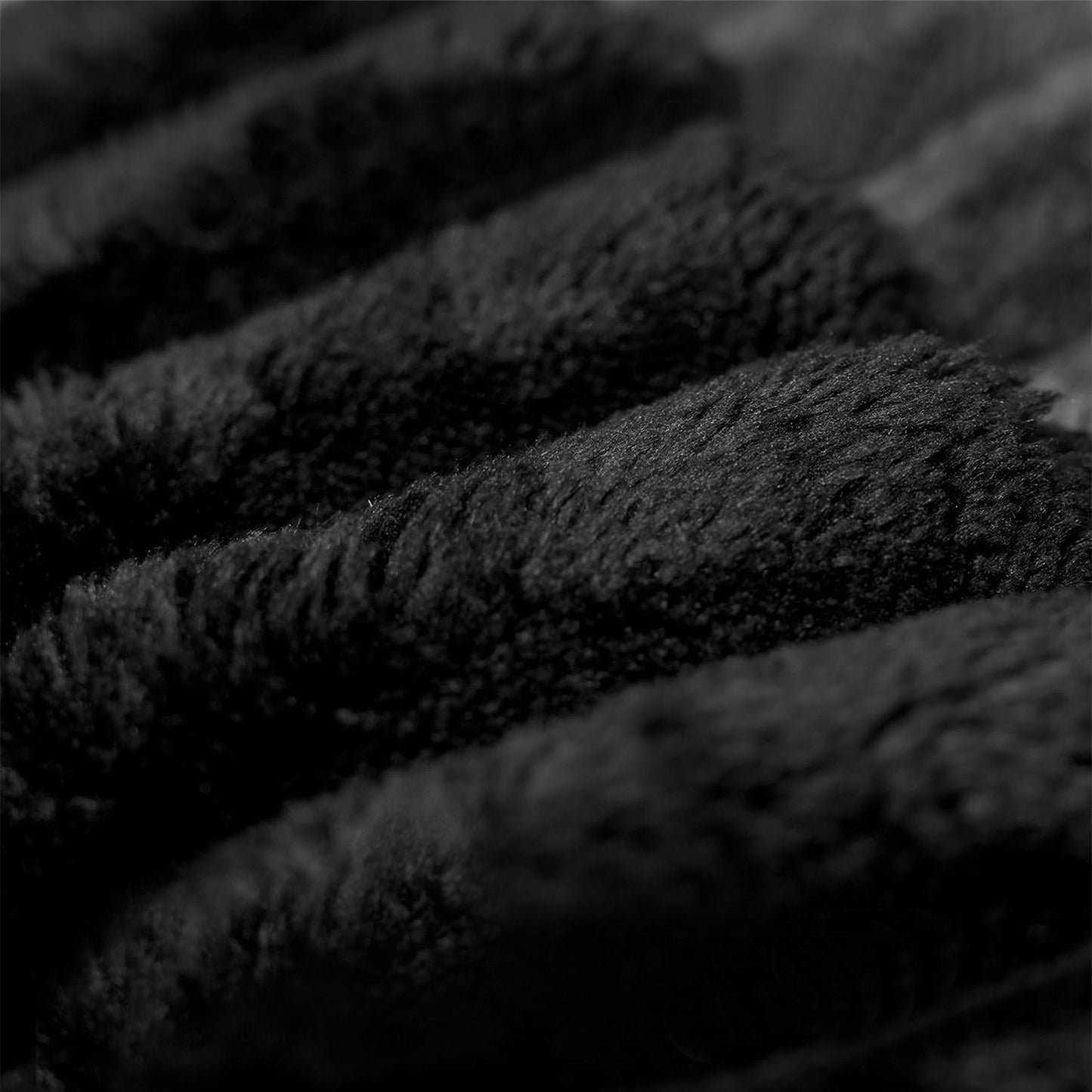 Close-up of the wide-wale black corduroy fabric and channel stitching — Black / 3-Seat