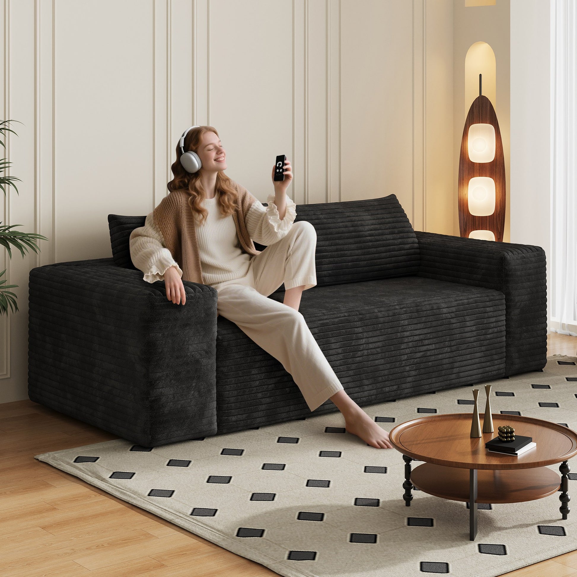 Woman relaxing on the black corduroy boneless sofa, 3-seat 78.8-inch, showing seat depth — Black / 3-Seat