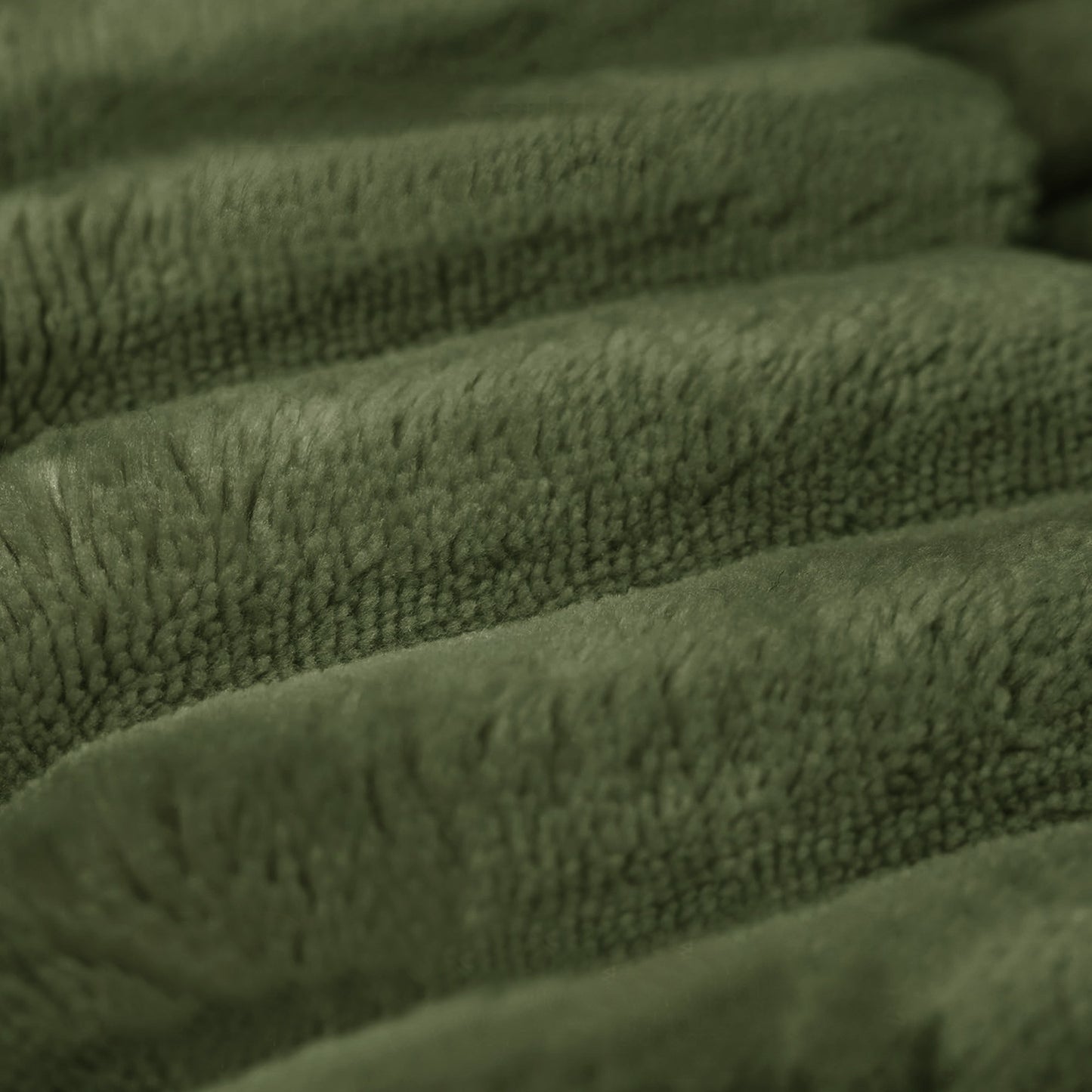 Close-up of the wide-wale green corduroy fabric and channel stitching — Green / 3-Seat