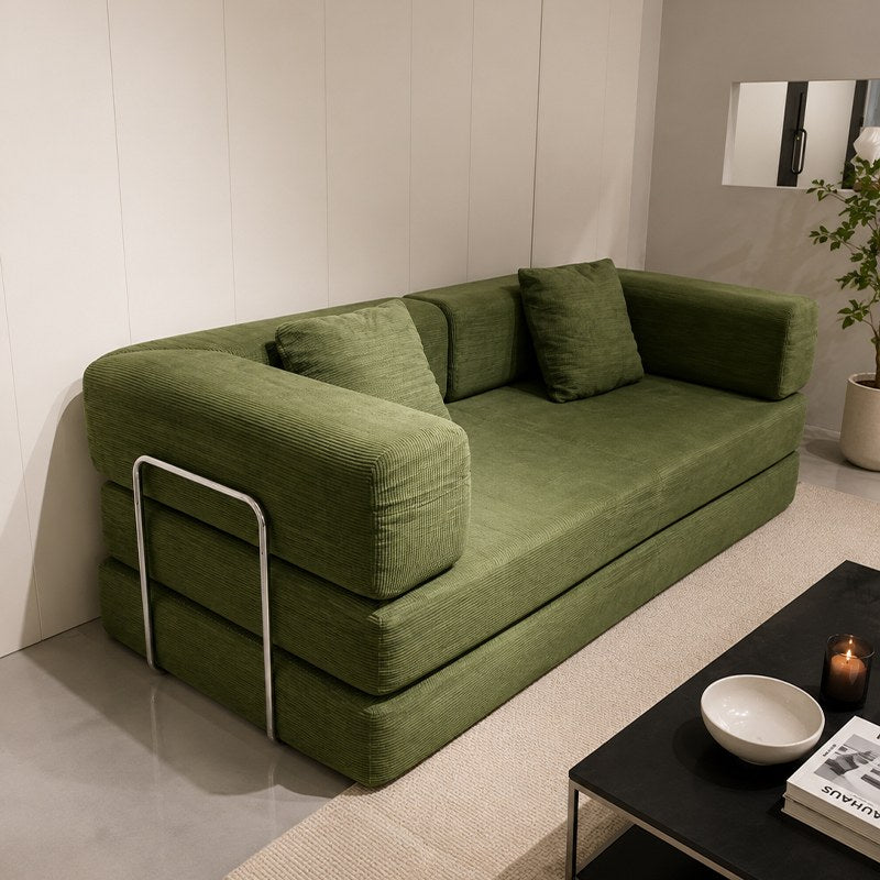 Green corduroy boneless sofa bed beside a coffee table in a bright room — Green