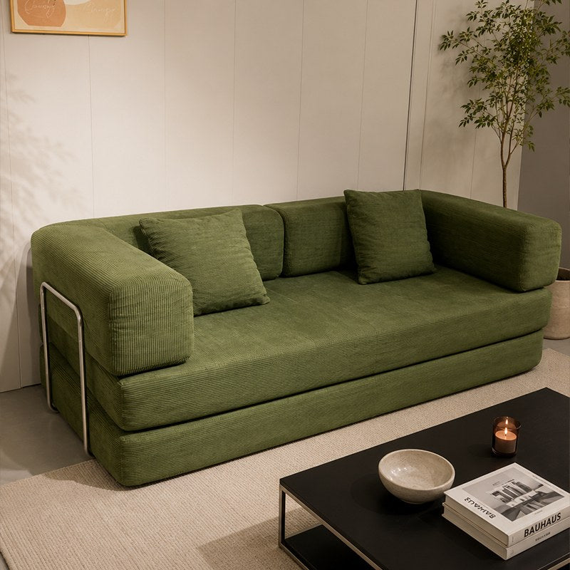 Green corduroy boneless sofa bed in a styled living room — Green