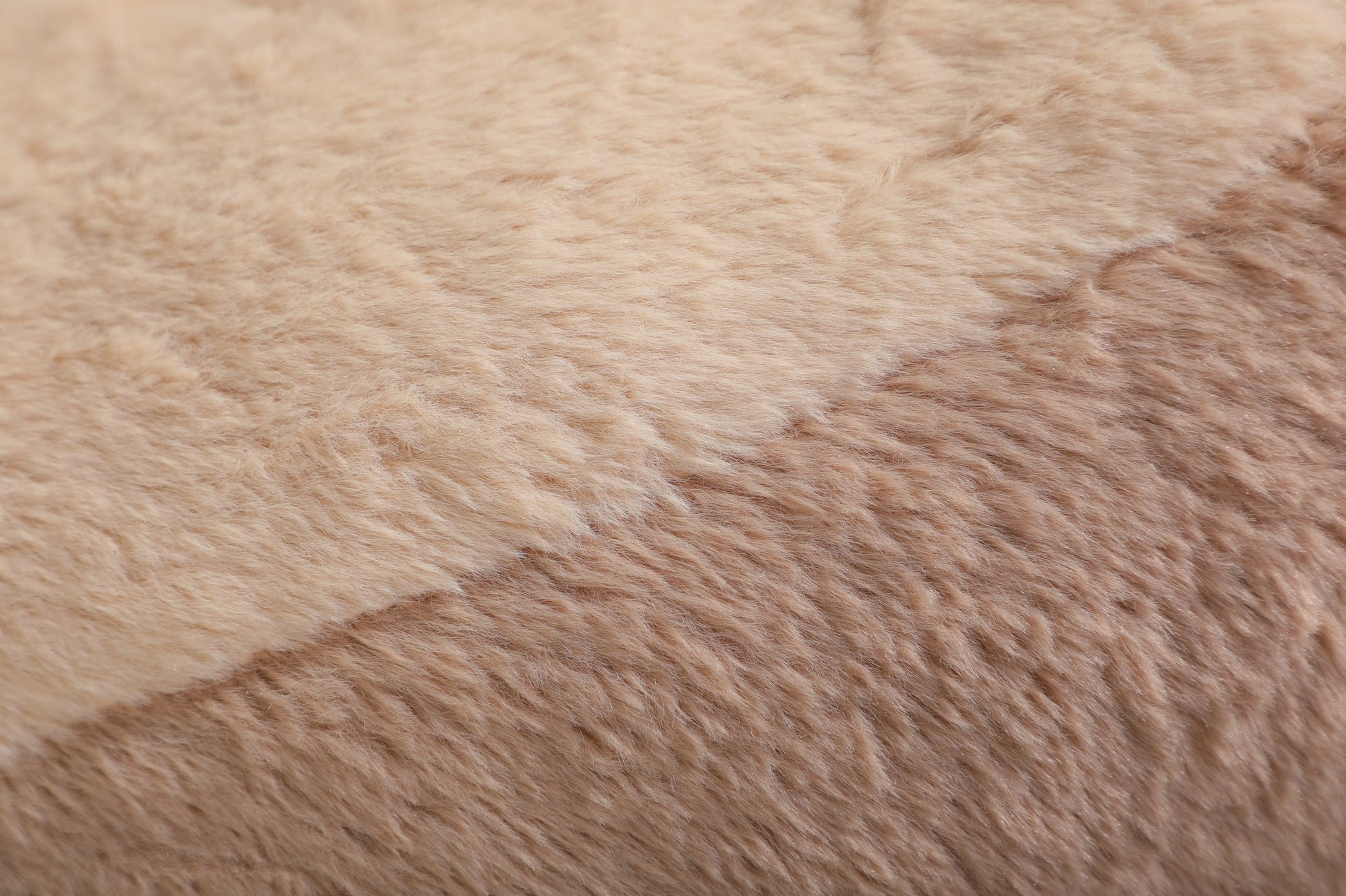 Close-up of the warm sand-beige faux fur pile on the boneless accent chair — Apricot