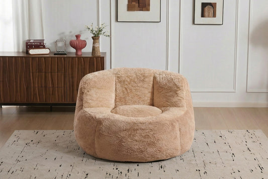Apricot faux fur boneless accent chair on a rug in a living room, showing its 43-inch footprint — Apricot