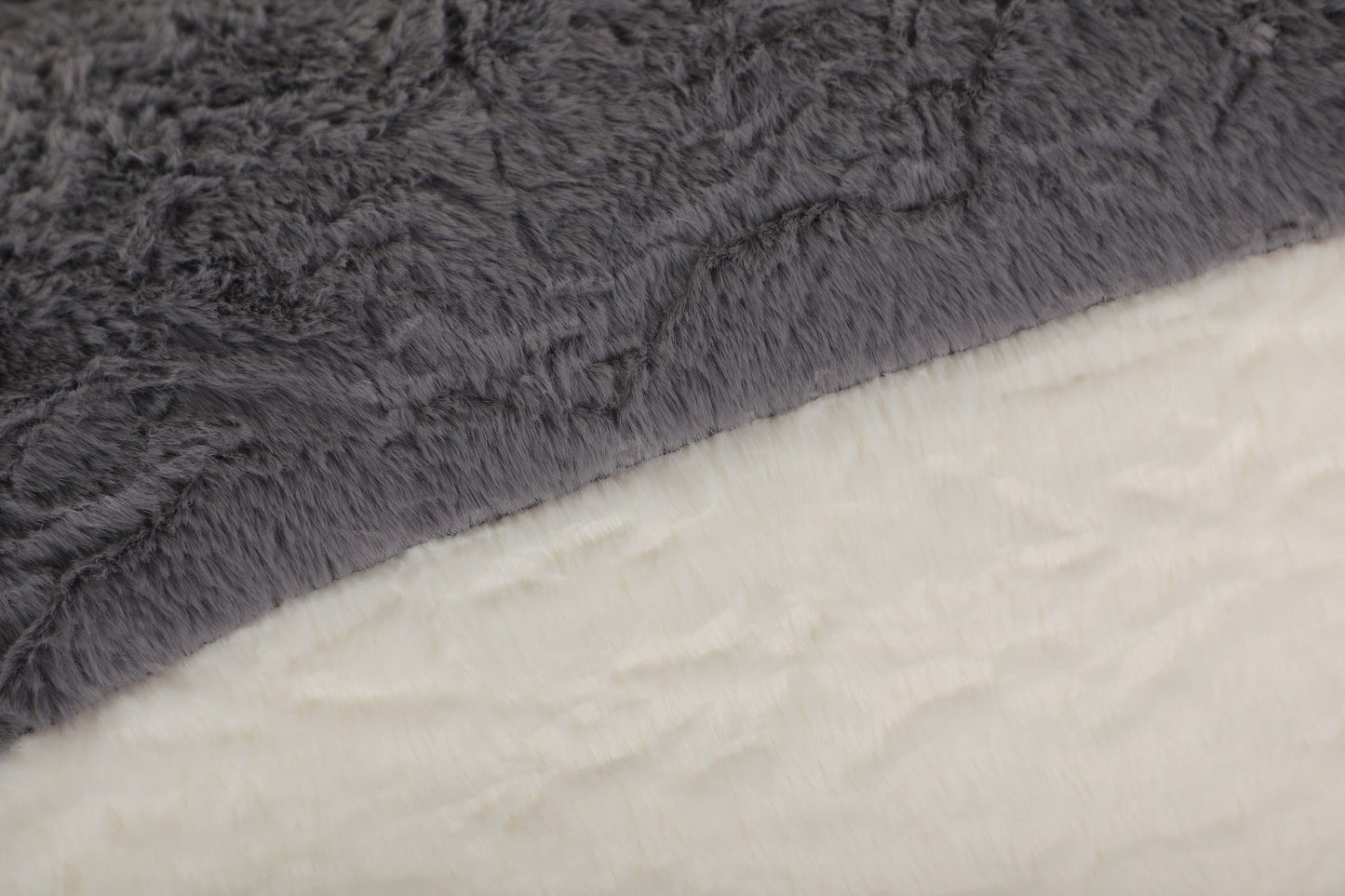 Close-up of the black, grey and cream faux fur pile on the boneless accent chair — Black
