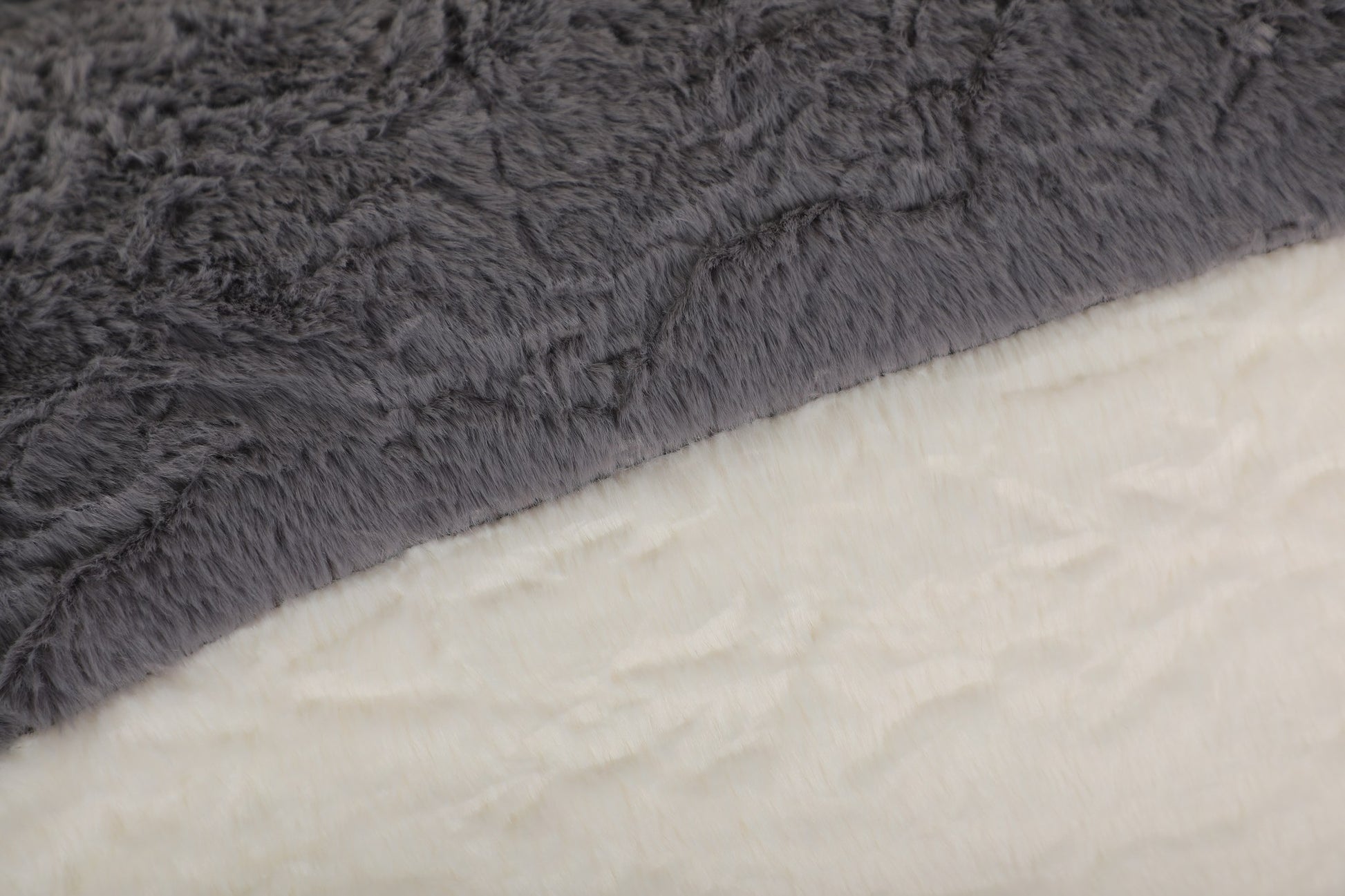 Close-up of the black, grey and cream faux fur pile on the boneless accent chair — Black