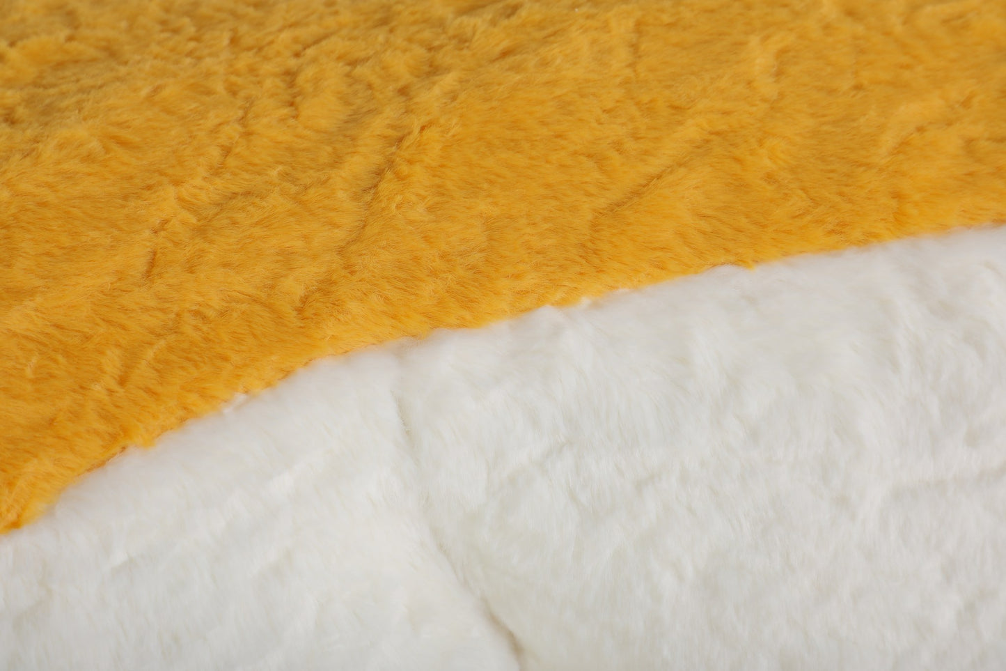 Close-up of the blue, mustard and cream faux fur pile on the boneless accent chair — Blue