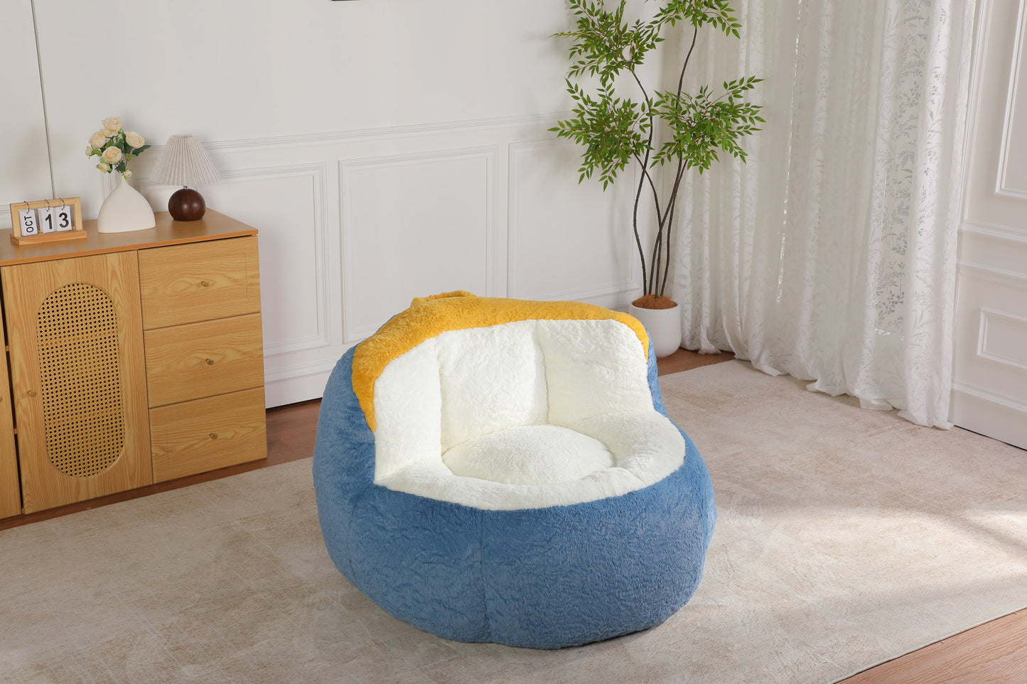 Blue faux fur boneless accent chair on a rug in a living room, showing its 43-inch footprint — Blue
