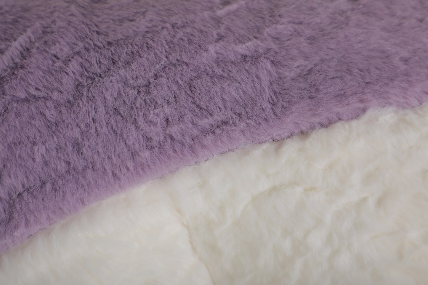 Close-up of the pink, lilac and cream faux fur pile on the boneless accent chair — Pink