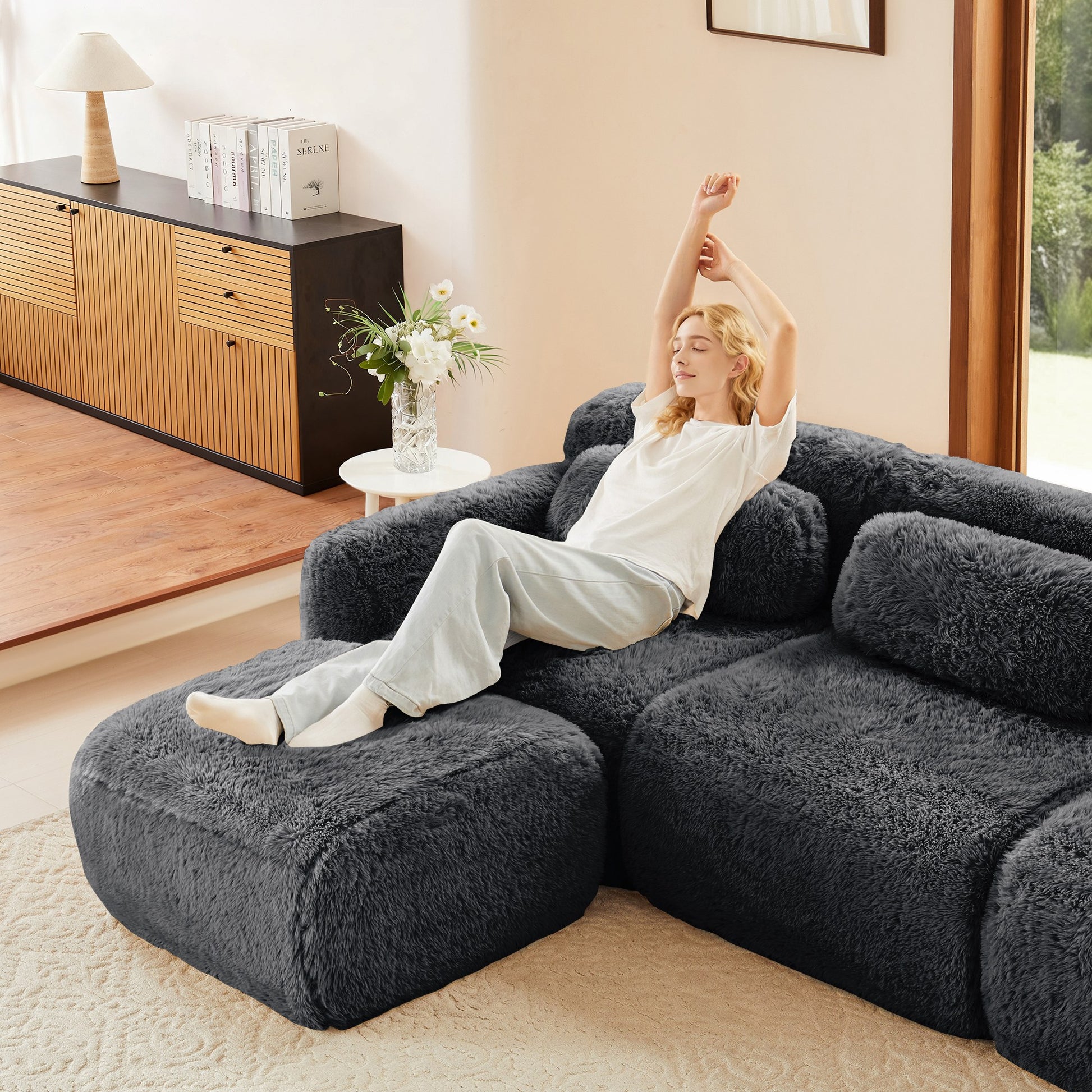 Dark grey plush boneless modules arranged as a corner sofa in a living room; this listing is one armless module — Dark Grey