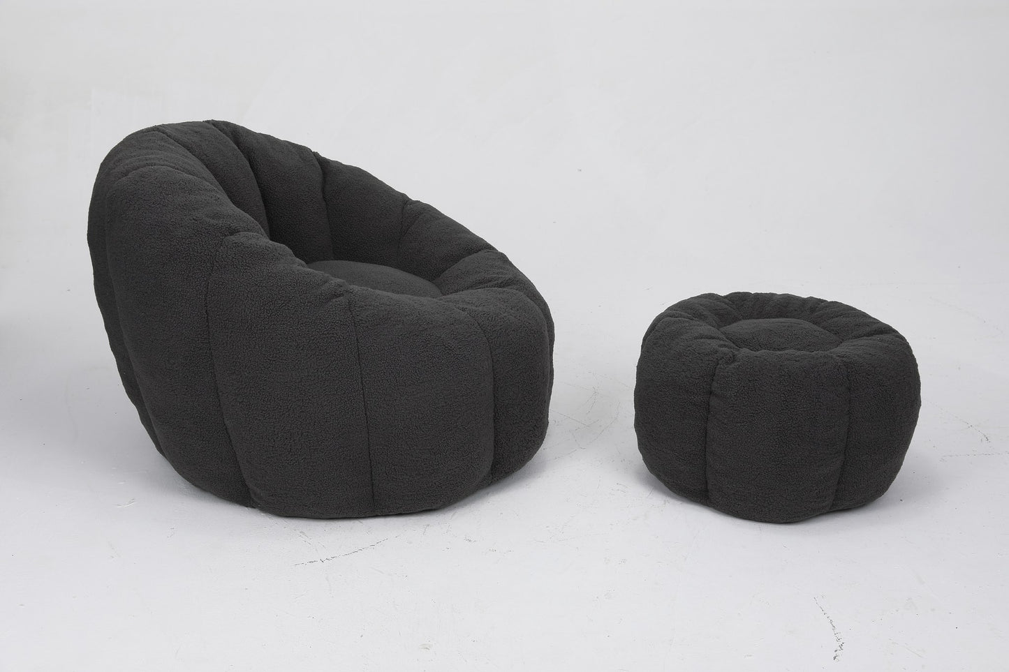 Charcoal teddy fleece accent chair and ottoman from the side on a plain white floor — Dark Gray / 1-Seat + 1 Ottoman